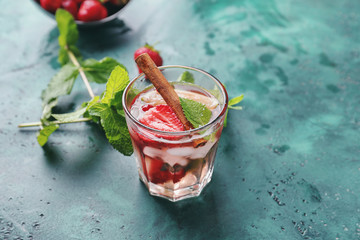 Glass with strawberry mojito on table