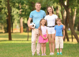 Fototapeta premium Happy family resting in park