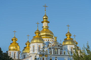Fototapeta na wymiar Golden domes of St. Michael Cathedral in Kiev, Ukraine. St. Michael's Golden-Domed Monastery - famous church complex in Kiev, Ukraine