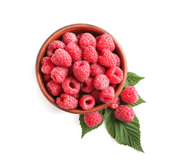 Bowl with ripe raspberries on white background