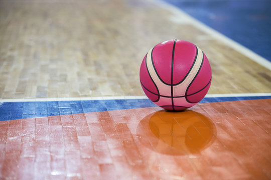 pink Basketball ball over floor in the gym