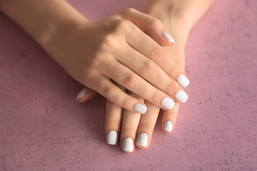 Female hands with stylish nails on color background, closeup