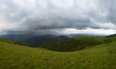 Mountain landscape and rain clouds among  peaks