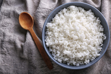Bowl with boiled white rice on table