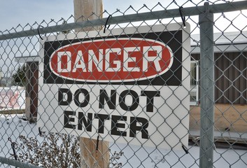 Danger do not enter sign hanging in the fence