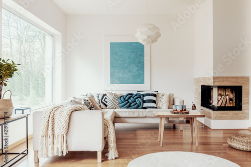 Turquoise Blue Knot Pillow On A Beige Corner Sofa And An Abstract Turquoise Blue Knot Pillow On A Beige Corner Sofa And An Abstract Poster White