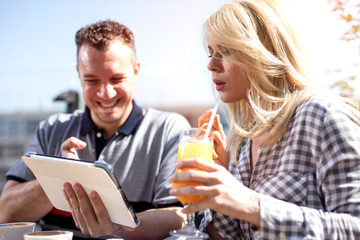 casual business couple  in cafe  working on digital tablet