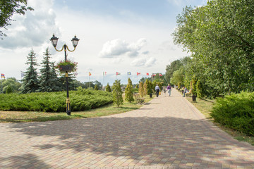 Fototapeta premium Beautiful walking avenue at the embankment in Myrgorod. At the territory of the resort.