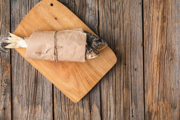 Dry fish on a wooden background