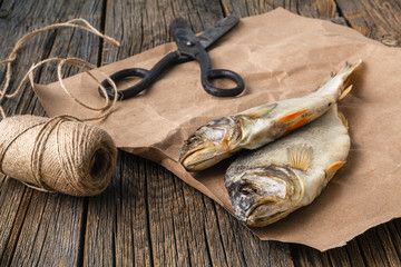 Dried salty herring fishes on a wooden table