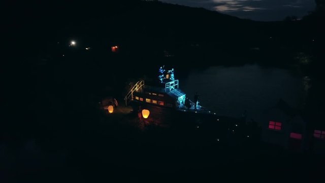 Aerial shot: Night action. A scene of recognition in love, a request of the hand and heart on the ship