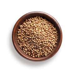 coriander in a wooden bowl, isolated on white