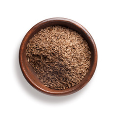 caraway seed in a wooden bowl, isolated on white