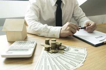 The capitalist is making a purchase approval. An accountant checks his money as collateral for the...