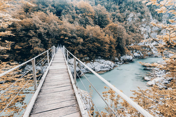 Wooden Bridge over rover Soca, Slovenia at autumn