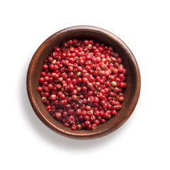 red pepper in a wooden bowl, isolated on white