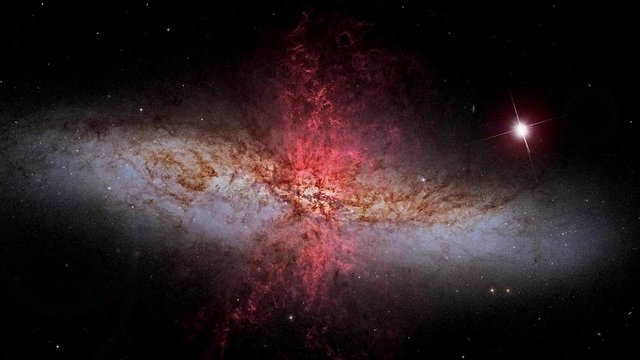 Galaxy Messier 82 slow rotating with near birght supernova star flare lights in outer space, 3D animation. Contains public domain image by NASA