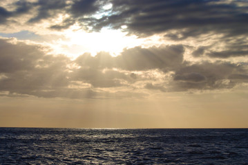 Naklejka na ściany i meble Sun Rays Through the Clouds over the Ocean