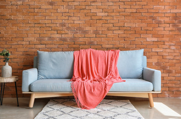 Warm pink plaid on sofa indoors