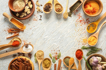 Frame made of different spices on light textured background