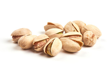 Roasted and salted pistachios, isolated on white background.