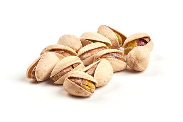 Roasted and salted pistachios, isolated on white background.