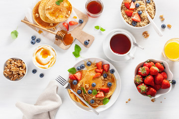 pancakes with blueberry strawberry honey and quinoa for breakfast