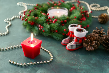 Burning candle and Christmas decorations on table
