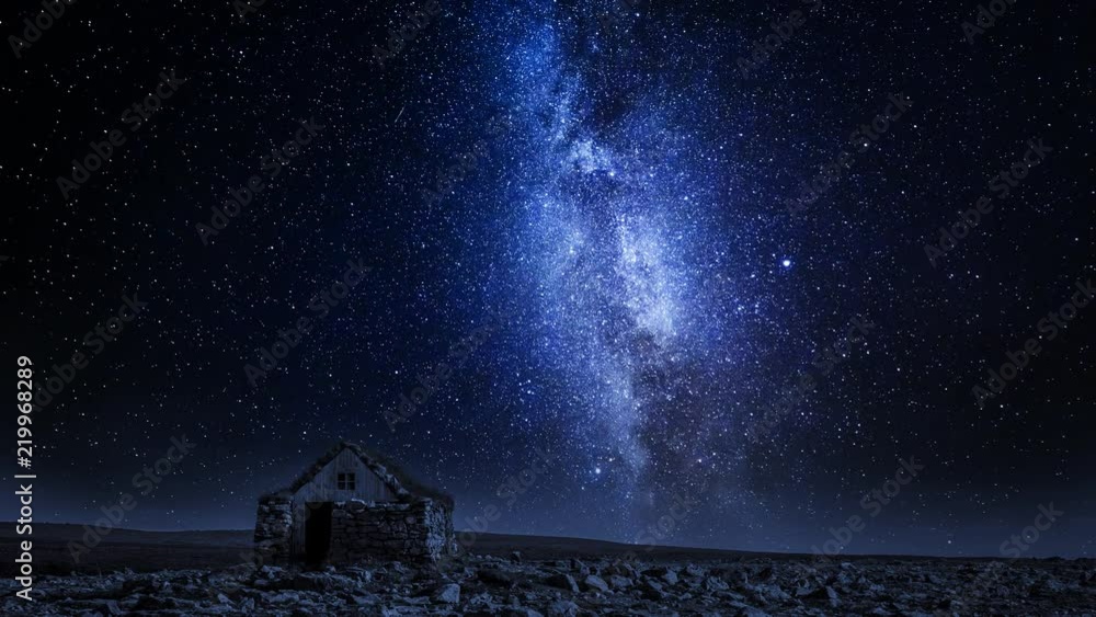 Wall mural small stone cottage and moving milky way at night, iceland, timelapse, 4k