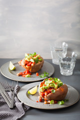 baked sweet potatoes with avocado chili salsa and beans