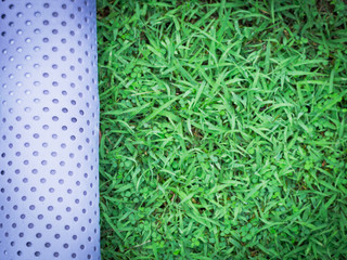 healthy lifestyle and outdoor concept from flat lay exercise object with yoka mat on grass with copy space background