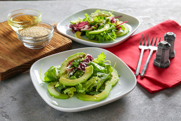 Plates with tasty vegetable salad on table