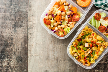 Lunch box with healthy food ready to eat on wooden table. Top view. Copyspace
