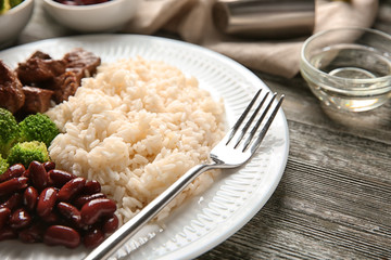 Tasty boiled rice with meat and vegetables on plate