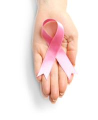 Woman holding pink ribbon on white background. Breast cancer awareness concept