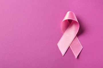 Pink ribbon on color background. Breast cancer awareness concept