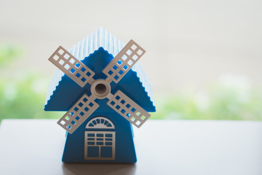 Closeup mini wind turbine blue house