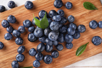 Ripe blueberries on wooden board