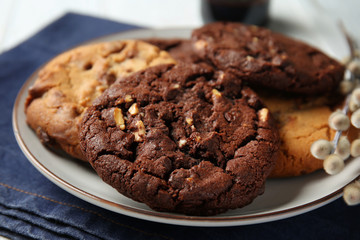 Plate with tasty cookies on table, closeup