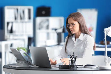 Young businesswoman working with laptop in office