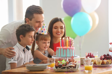 Happy family celebrating birthday at party