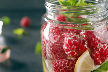 Fototapeta na wymiar Glass jar of fresh raspberry mojito, closeup