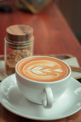 Cup of coffee latte art on the table empty cafe