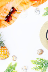 Tropical summer concept with woman fashion accessories, leaves and pineapple on white background. Flat lay, top view