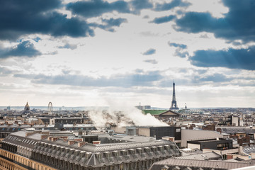 Sun rays over the beautiful Paris City seen from a rooftop in a cold winter day