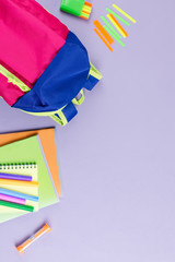 Fototapeta premium School concept flat lay. Kid backpack, notebook, markers on wooden desktop
