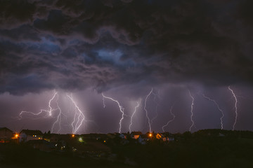 Summer thunderstorm and lightnings. Composite photography.