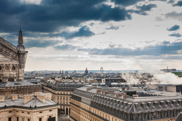 Fototapeta na wymiar Sun rays over the beautiful Paris City seen from a rooftop in a cold winter day