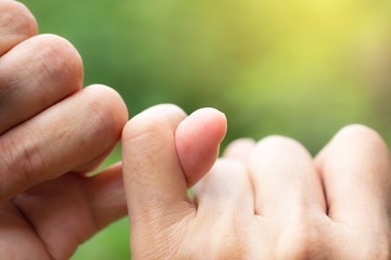 Pinky fingers of buddies in nature background promise is important for people in the world.