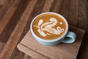Latte art coffee cup  on wooden table